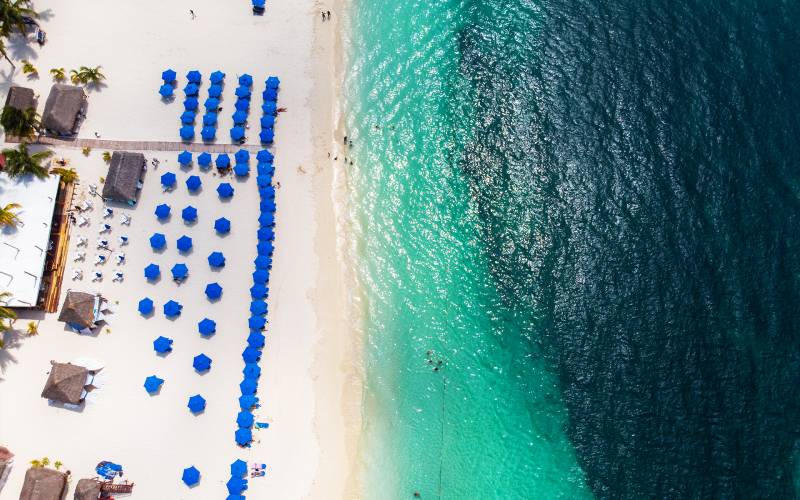 Aerial view of the beach with hammocks and umbrellas