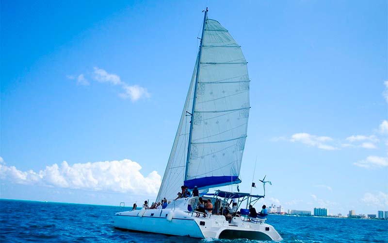 catamaran boat in the waters of the caribbean sea off isla mujeres